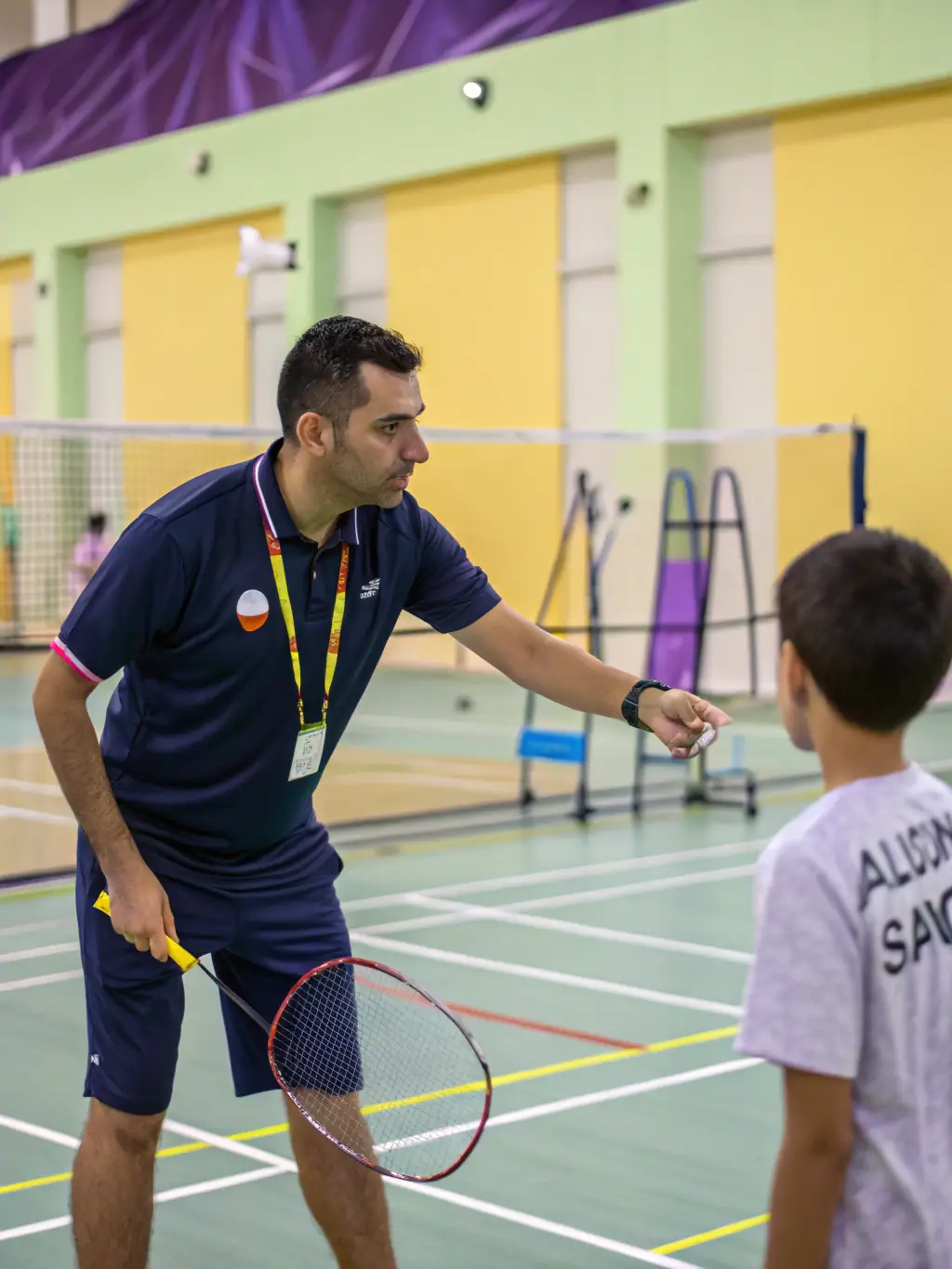 A high-quality photo of a CSM table tennis coach providing personalized instruction to a player, showcasing the club's commitment to individual skill development.
